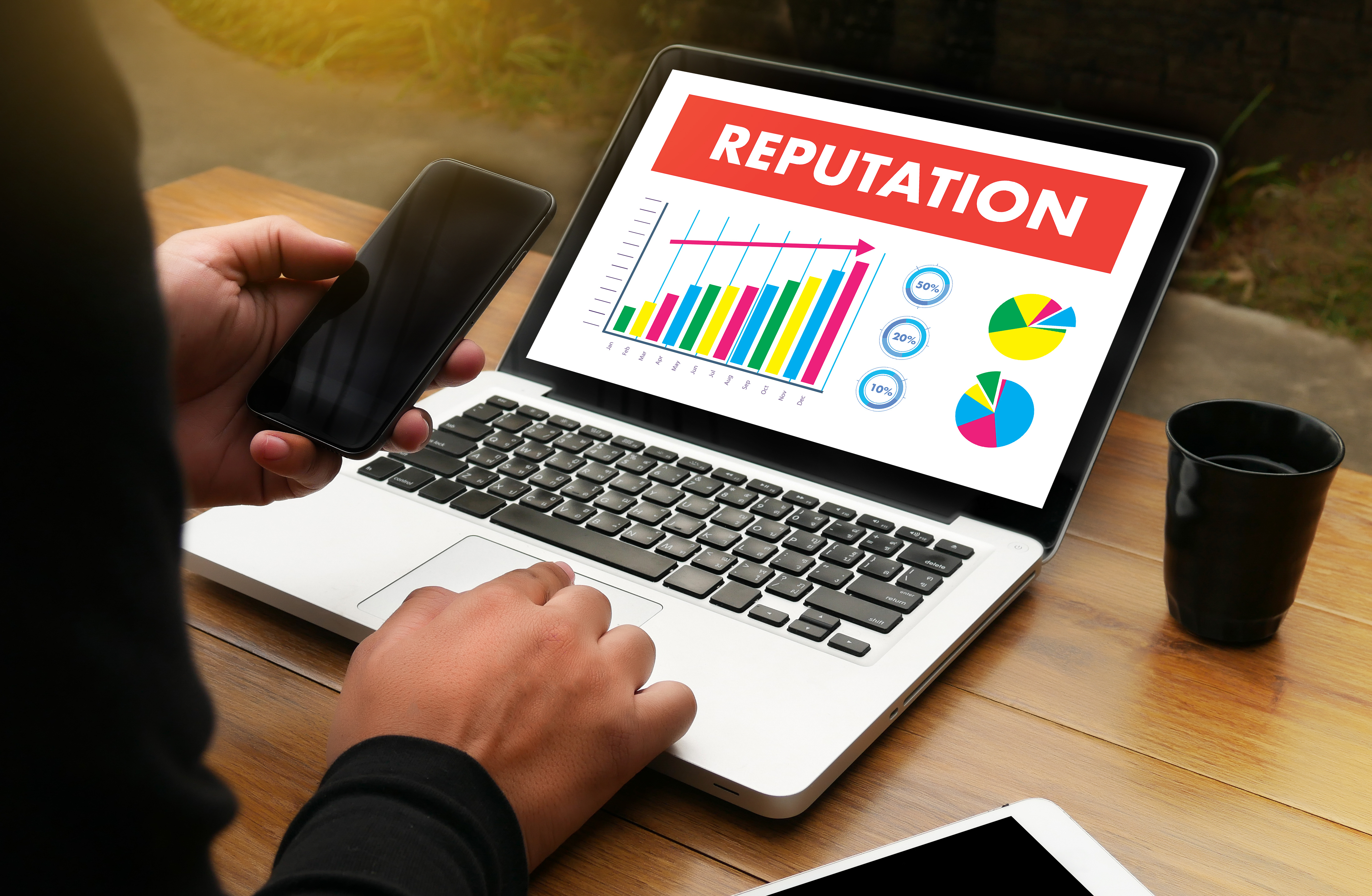 A laptop showing a chart that indicates an improvement in reputation